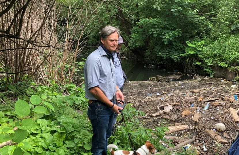 Matthew Offord MP viewing sewage at the Welsh Harp in West Hendon