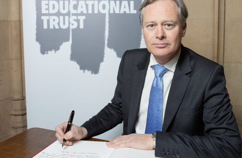 Matthew Offord MP signing the Holocaust Memorial Day book of commitment 