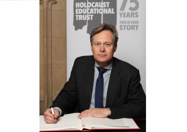 Matthew Offord MP signing the Holocaust Memorial Trust book in Parliament