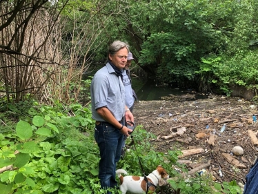 Matthew Offord MP viewing sewage at the Welsh Harp in West Hendon